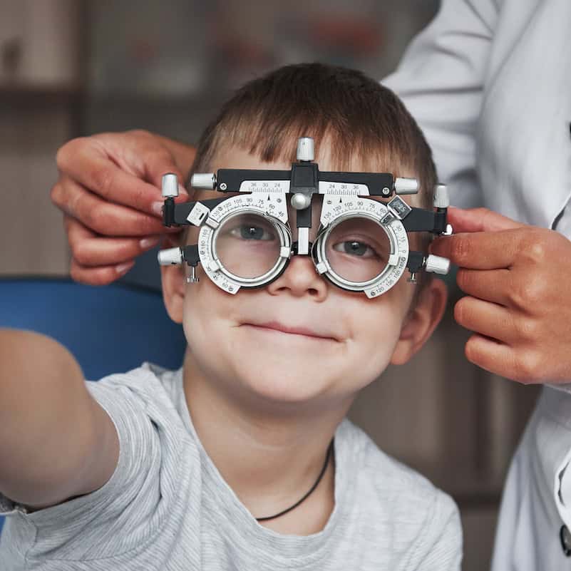Child getting an eye test with a smile